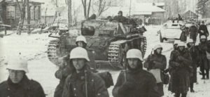 Deutsche Panzerfahrzeuge und Infanteristen auf dem Marsch in eisiger Kälte 